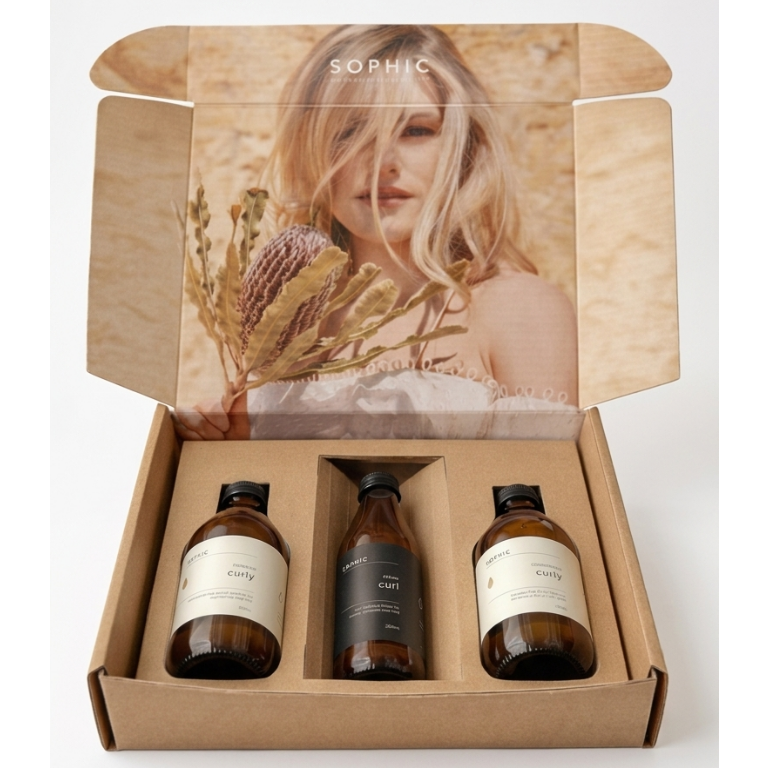 Skincare product set with three bottles in a box featuring a photo of a woman on the lid.