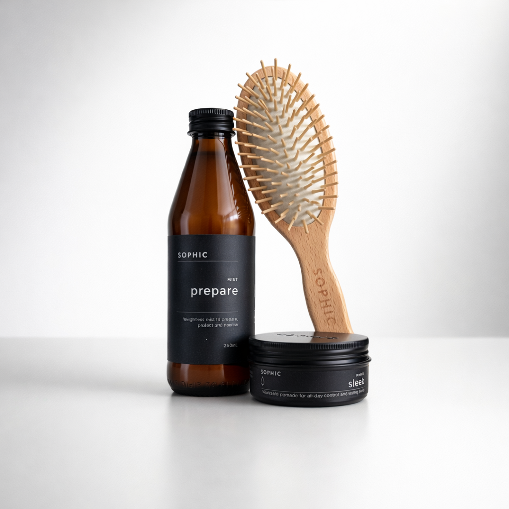 SOPHIC hair care products including a bottle, brush, and container on a white background