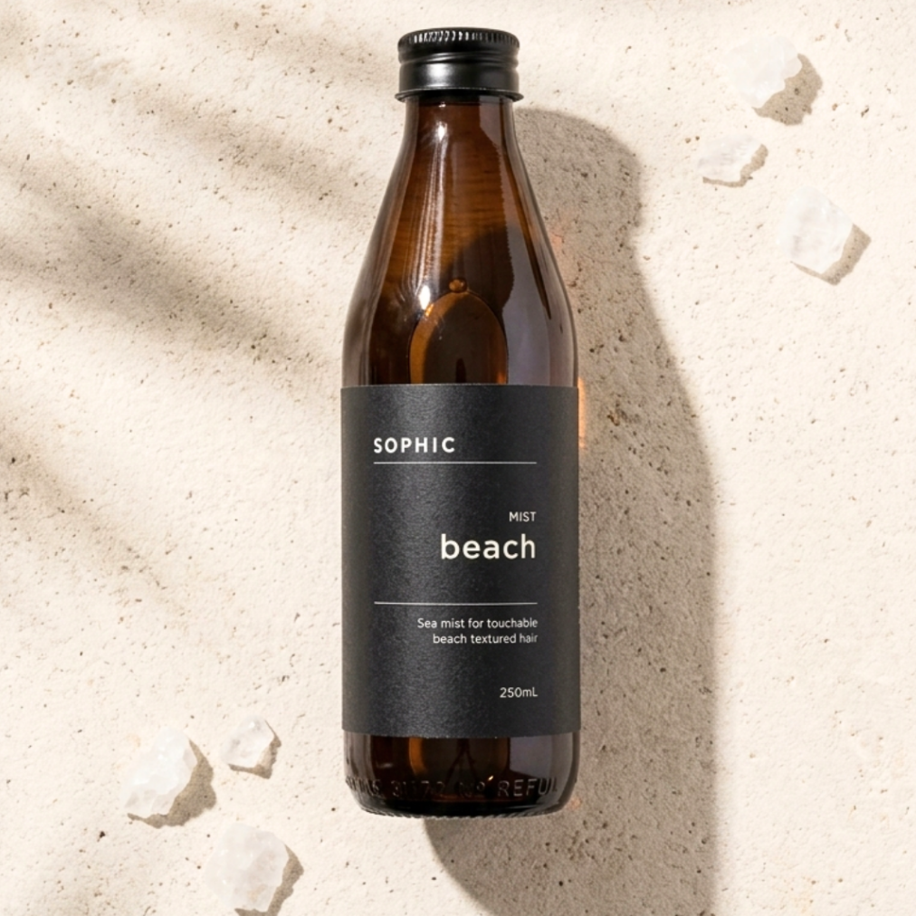 Brown bottle with a label on a sandy background