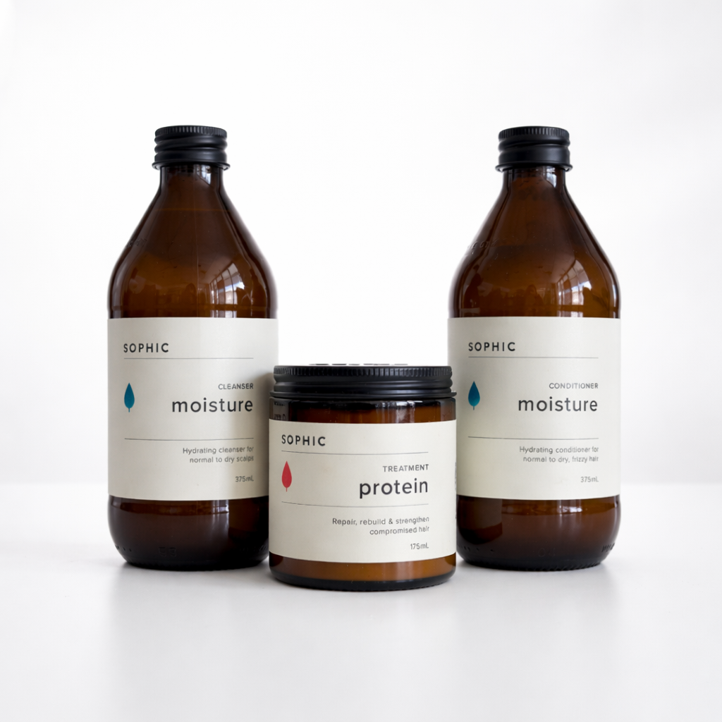 Set of three SOPHIC hair care products on a white background