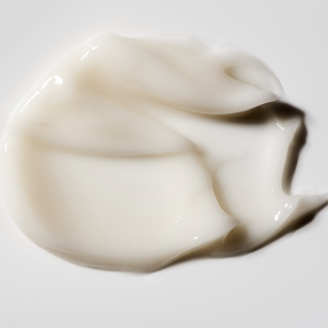 Melted white cream on a gray background